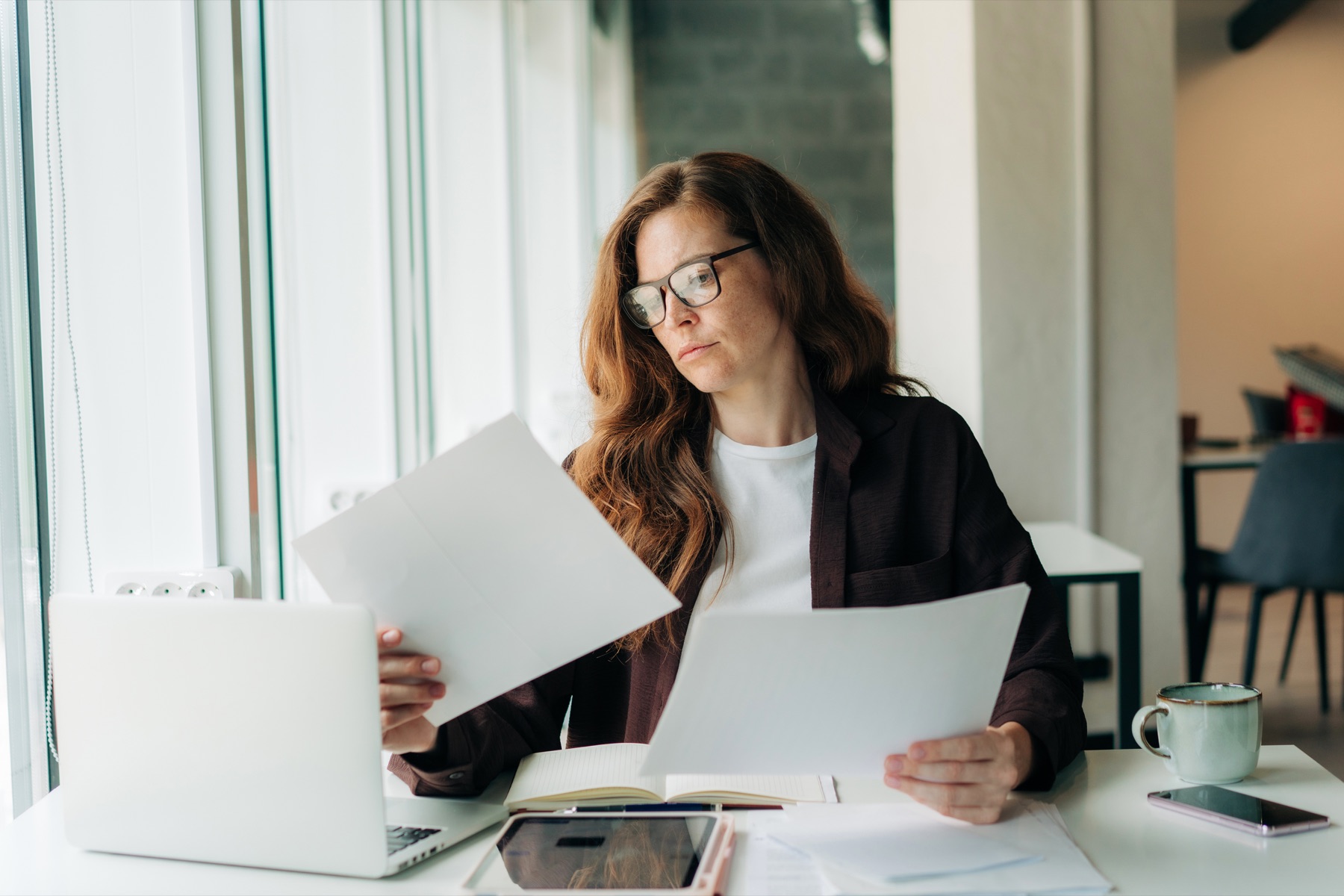Professional reviewing project notes and data